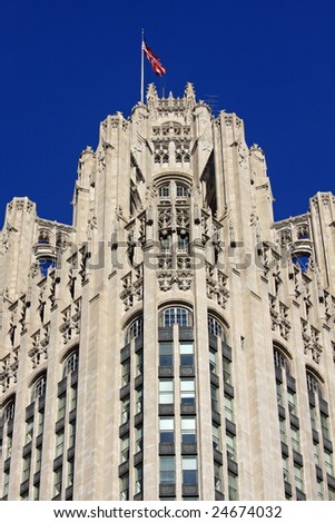 Neo-gothic architecture on Chicago Tribune Building, framed with clear blue sky