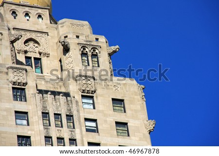 Stunning decorative architecture with birds and gargoyles framed by clear blue sky