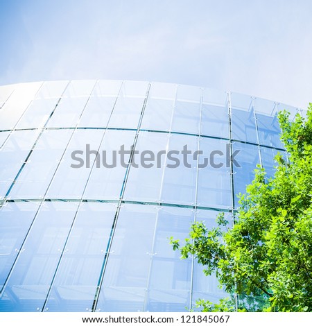 Business office building and green oak, business and nature concept