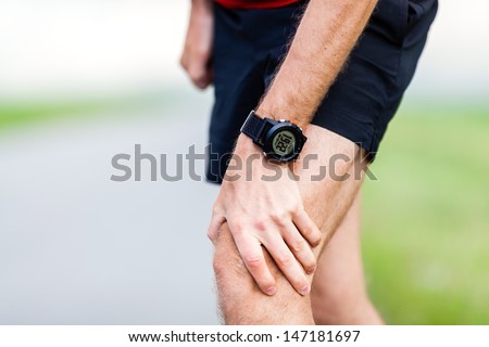 Runner leg and muscle pain during running training outdoors in summer nature, sport jogging physical injury, workout. Health and fitness concept