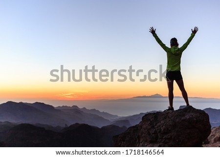 Woman successful hiking or climbing in mountains, motivation and inspiration in beautiful sunset landscape. Female hiker with arms up outstretched on mountain top looking at view. Photo stock © 