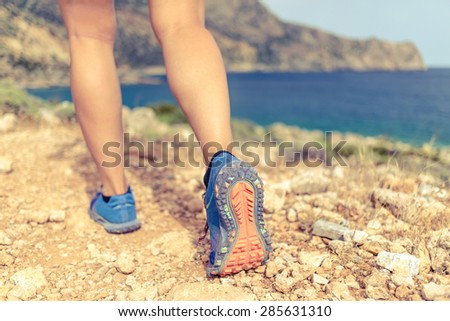 Walking running hiking or exercising, sports shoe and legs on rocky hiking trail in mountains, motivation inspiration concept outdoors, achievement fitness adventure and exercising in wild nature