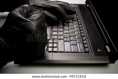 Security concept with mad hacker working on laptop at night, internet crime