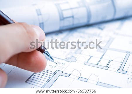 House blueprints and architect hand with pencil drawing