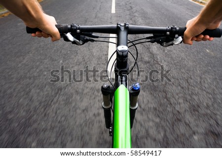 Bicycle rider riding real fast on mountain bike, motion blur