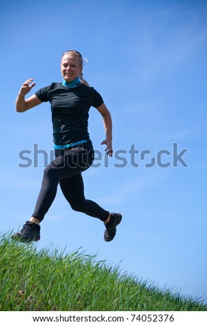 Woman training cross country running in spring nature