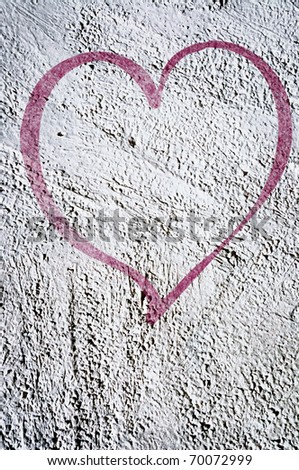 Grunge background with graffiti, writings and a painted purple heart on a concrete wall