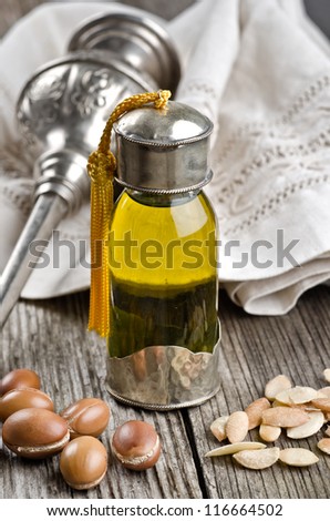 Bottle of argan oil and argan fruit. Argan oil is used for skincare products.