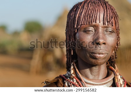 TURMI, ETHIOPIA - 12 AUGUST: portrait of unidentified Hamer tribe woman, Omo valley, 12 august 2014. Hamer woman usually comb their hairs with soil and wear many colored necklace