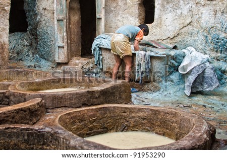 FEZ, MOROCCO - OCTOBER 24: unidentified man works in a tannery of Fez, Morocco, October 24, 2011. In Fez there are the most ancient tanneries in the world and leathers are worked as centuries ago.