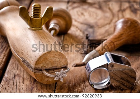 Still life of goldsmith\'s tools with diamonds ring