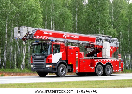 CHELYABINSK REGION, RUSSIA - AUGUST 14, 2009: Red Scania P380 fire ladder at the interurban road.