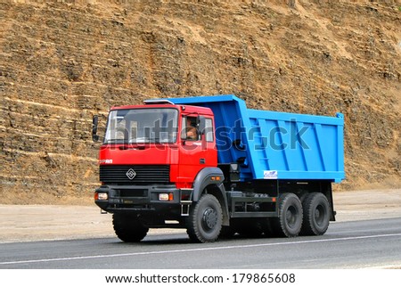 CHELYABINSK REGION, RUSSIA - AUGUST 2, 2008: Red and blue URAL 63685 dump truck at the quarry.