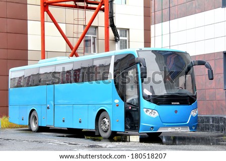 NOVYY URENGOY, RUSSIA - SEPTEMBER 1, 2012: Cyan Scania OmniExpress 340 interurban coach at the city street.