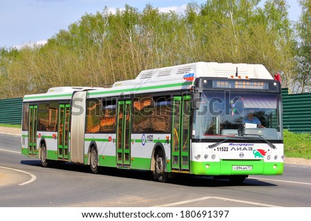 MOSCOW, RUSSIA - MAY 9, 2013: White and green LIAZ 6213 articulated city bus ran on a gas fuel at the city street.