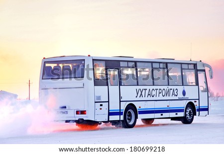 NOVYY URENGOY, RUSSIA - FEBRUARY 24, 2013: White KAVZ 4328 Aurora interurban coach at the city street.