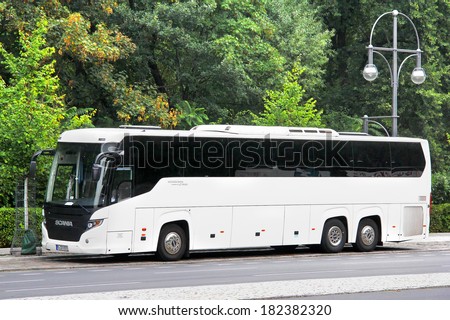 BERLIN, GERMANY - SEPTEMBER 11, 2013: White Scania Touring interurban coach at the city street.