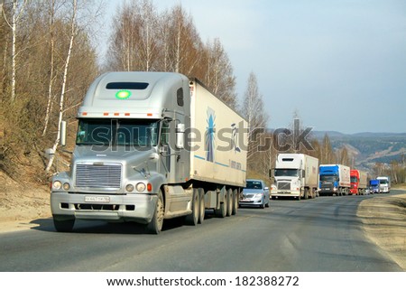 CHELYABINSK REGION, RUSSIA - MAY 1, 2008: Silver Freightliner Century Class semi-trailer truck at the interurban road.