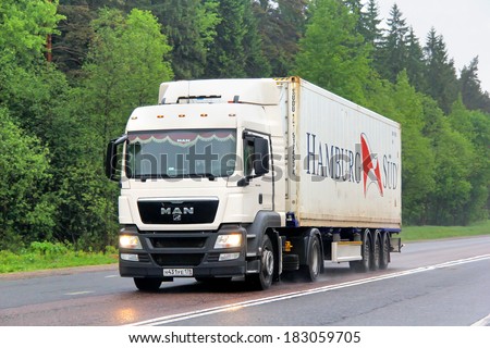 TVER REGION, RUSSIA - MAY 22, 2013: White MAN TGX semi-trailer truck at the interurban road.