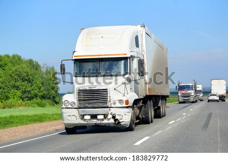 TATARSTAN, RUSSIA - MAY 29, 2013: White Freightliner Century Class semi-trailer truck at the interurban road.