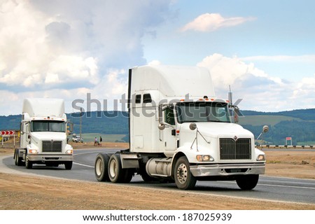 SIM, RUSSIA - AUGUST 2, 2008: White International 9400i semi-trailer trucks at the interurban road.