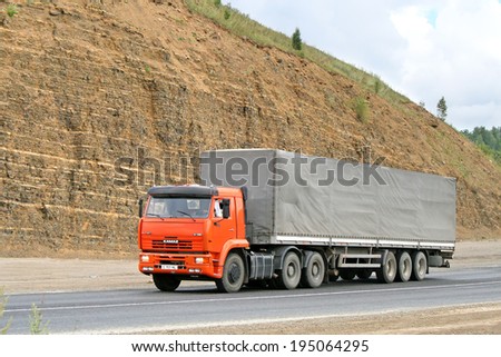 SIM, RUSSIA - AUGUST 2, 2008: Orange KAMAZ 6460 semi-trailer truck at the interurban road.
