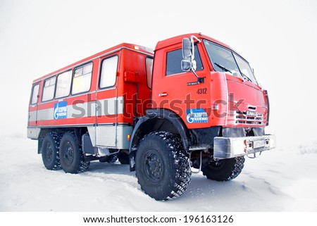 YAMAL, RUSSIA - NOVEMBER 23, 2012: Orange KAMAZ 43114 off-road bus in the snow-covered tundra.
