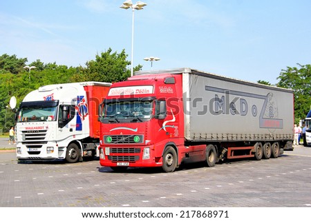 GERMANY - JULY 20, 2014: Modern trucks Volvo FH12 and Iveco Stralis at the parking near the interurban freeway.
