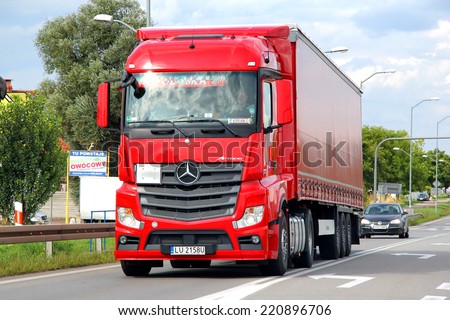 SZCZECIN, POLAND - AUGUST 13, 2014: Red semi-trailer truck Mercedes-Benz Actros at the interurban freeway.