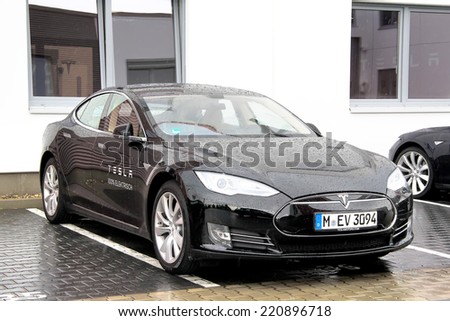 BERLIN, GERMANY - AUGUST 15, 2014: American electric sedan Tesla Model S at the city street.