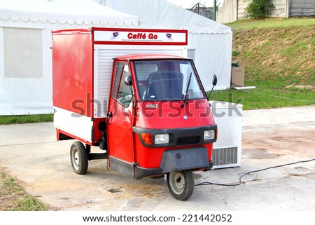 BUDAPEST, HUNGARY - JULY 25, 2014: Red three-wheeled light commercial vehicle Piaggio Ape 50 at the city street.