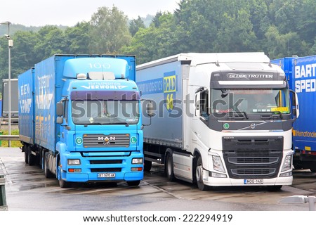 AUSTRIA - JULY 28, 2014: Modern trucks MAN TGA and Volvo FH12 at the interurban freeway.
