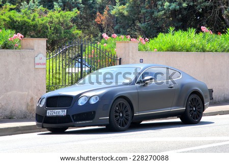 SAINT-TROPEZ, FRANCE - AUGUST 3, 2014: Black luxury car Bentley Continental GT at the city street.
