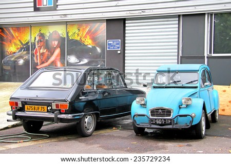 PARIS, FRANCE - AUGUST 7, 2014: French retro cars Renault 16 and Citroen 2CV at the city street.
