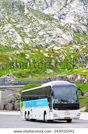 GOTTHARD PASS, SWITZERLAND - AUGUST 5, 2014: White touristic coach MAN R08 Lion\'s Top Coach at the high Alpine mountain road.