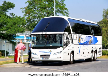 BRANDENBURG, GERMANY - JULY 20, 2014:  White luxury intercity coach Neoplan N5217/3SHD Starliner at the parking near the interurban freeway.