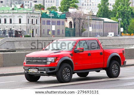 MOSCOW, RUSSIA - JULY 7, 2012: Red pickup truck Ford F-150 Raptor at the city street.