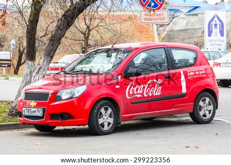 ANAPA, RUSSIA - NOVEMBER 21, 2014: Red Coca-Cola car Chevrolet Aveo at the city street.