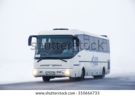 NOVYY URENGOY, RUSSIA - JANUARY 12, 2013: Intercity coach SOR LH10.5 Arktika at the interurban freeway during a heavy northern blizzard.