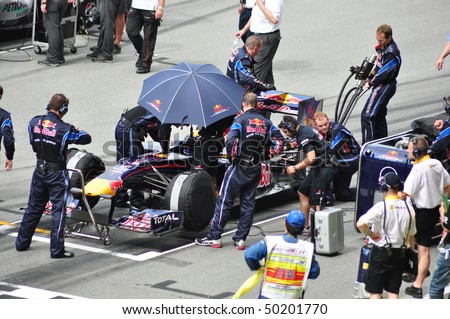 SEPANG, MALAYSIA - APRIL 4: Crew prepare Mark Webber\'s car of Red Bull Racing Team at Malaysian F1 Grand Prix April 4, 2010 at Sepang International Circuit in Malaysia.