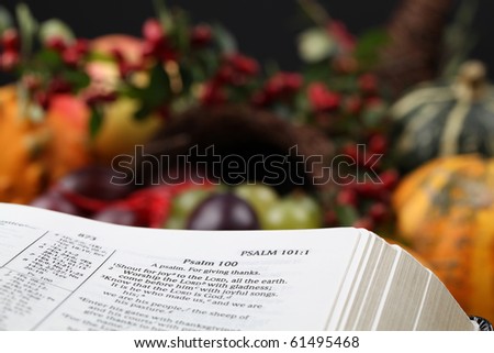 Bible open to Psalm 100 with thanksgiving text and cornucopia in background.