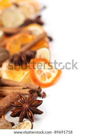 Christmas border with Christmas spices and dried orange slices isolated on white background