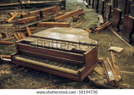 Destroyed piano in an abandoned church.