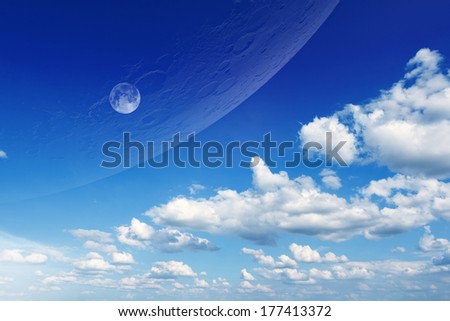 Abstract fantastic background - aliens planet approaching planet Earth. Blue sky with white clouds and moon. Elements of this image furnished by NASA