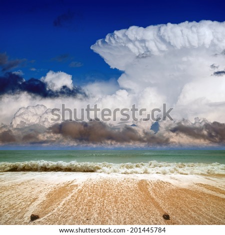 Beautiful seascape - blue sea and sky, waves, big white cloud incus