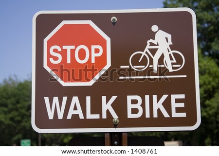 Sign ordering bikers to Stop and Walk Bike - not sharpened.