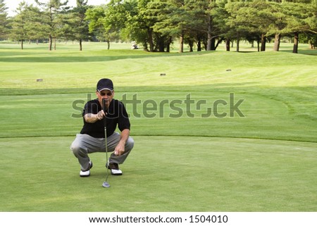 Male golfer plumbing the next putt.  Not sharpened in camera or when converted from RAW.