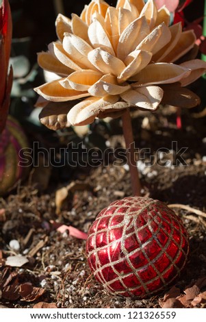 A Christmas ornament sparkles under dried flowers in a pot in Santa Fe, New Mexico
