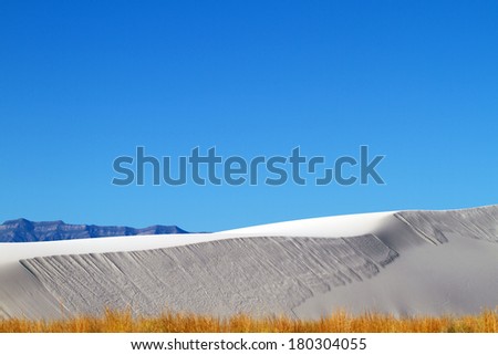 Sand sky mountains dry grasses