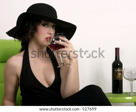 Young woman with old fashioned hat drinking wine